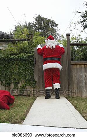 Santa peering over fence gate View Large Photo Image Stock Photo - Santa peering over fence gate. Fotosearch