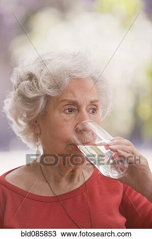 Senior Chilean woman drinking water View Large Photo Image Stock Image - Senior Chilean woman drinking water. Fotosearch