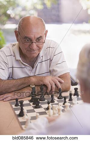 Senior men playing chess outdoors View Large Photo Image Stock Photograph - Senior men playing chess outdoors. Fotosearch