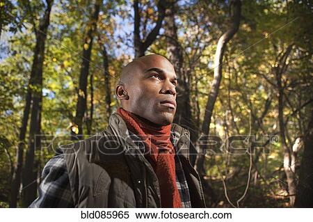 Stock Photography - Serious African American man in woods. Fotosearch