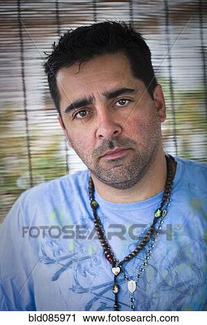 Stock Image - Serious Caucasian man with beard stubble. Fotosearch