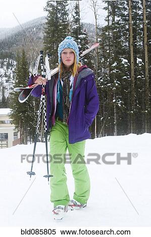 Stock Photography - Skier carrying skis and ski poles. Fotosearch