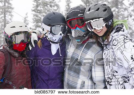 Stock Photo - Skiers hugging in the snow. Fotosearch