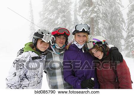 Stock Image - Skiers standing in snow. Fotosearch