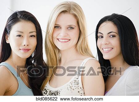 Stock Image - Smiling friends standing together. Fotosearch