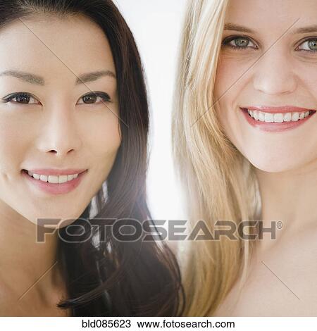 Smiling friends standing together View Large Photo Image Stock Image - Smiling friends standing together. Fotosearch