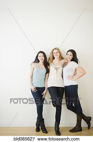 Stock Photo - Smiling friends standing together. Fotosearch