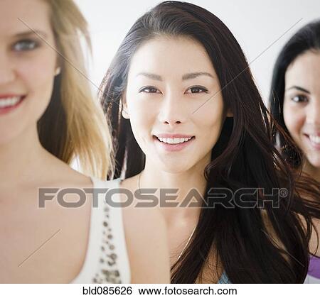 Smiling friends standing together View Large Photo Image Stock Photograph - Smiling friends standing together. Fotosearch