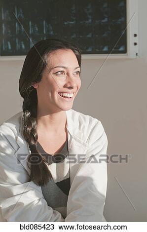 Stock Image - Smiling Hispanic doctor in hospital. Fotosearch