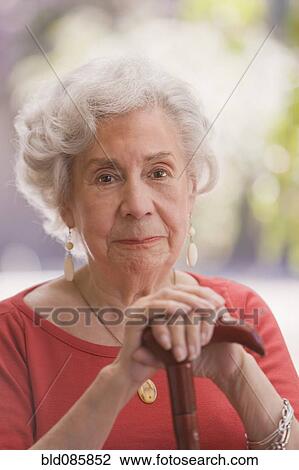 Stock Image - Smiling senior Chilean woman with cane. Fotosearch