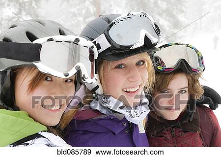 Smiling skiers hugging View Large Photo Image Stock Photo - Smiling skiers hugging. Fotosearch