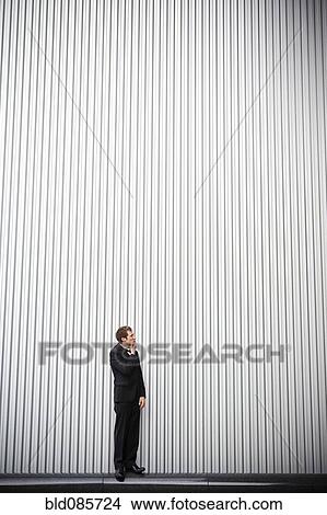 Uncertain groom standing near wall View Large Photo Image Picture - Uncertain groom standing near wall. Fotosearch