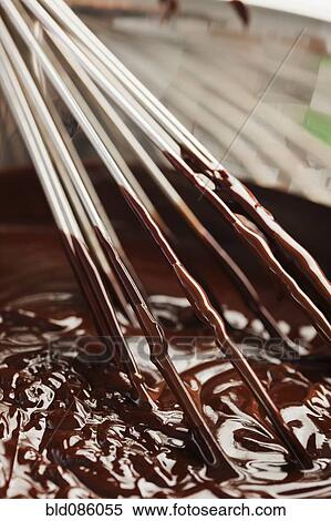 Stock Photography - Whisk in bowl of melted chocolate. Fotosearch