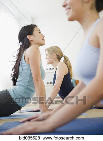 Stock Photo - Women in yoga class. Fotosearch