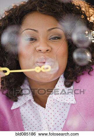 African American woman blowing bubbles View Large Photo Image Stock Photograph - African American woman blowing bubbles. Fotosearch