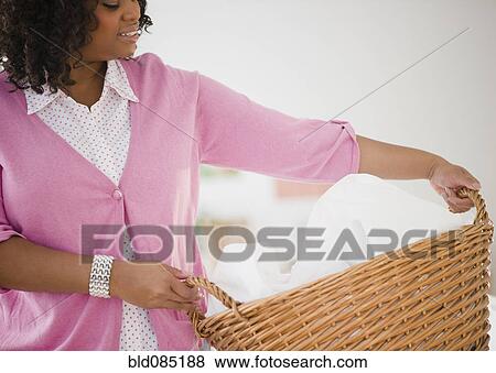 African American woman carrying laundry basket View Large Photo Image Stock Photo - African American woman carrying laundry basket. Fotosearch