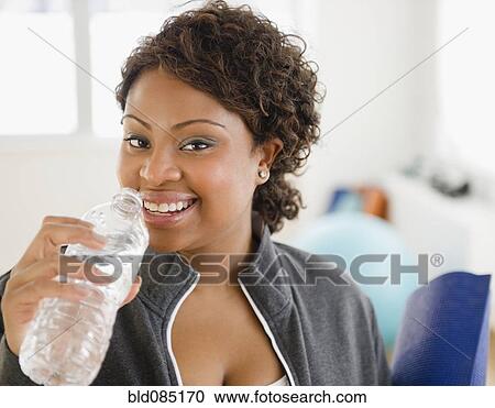 African American woman drinking water View Large Photo Image Stock Image - African American woman drinking water. Fotosearch