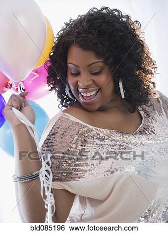 African American woman holding balloons View Large Photo Image Stock Photograph - African American woman holding balloons. Fotosearch