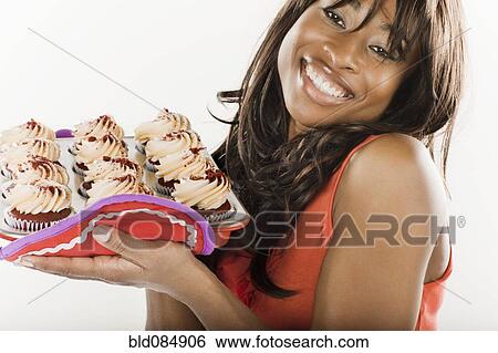 African American woman holding cupcakes View Large Photo Image Stock Photograph - African American woman holding cupcakes. Fotosearch