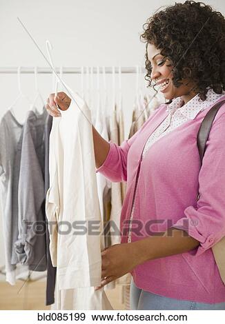 African American woman shopping for clothing View Large Photo Image Stock Photo - African American woman shopping for clothing. Fotosearch