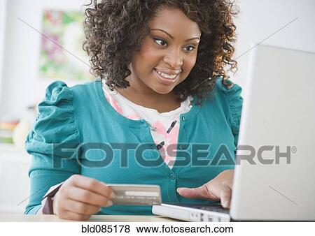 African American woman shopping online with credit card View Large Photo Image Stock Photo - African American woman shopping online with credit card. Fotosearch