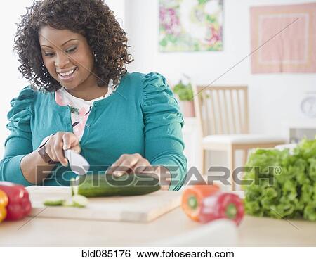 African American woman slicing vegetables View Large Photo Image Stock Photograph - African American woman slicing vegetables. Fotosearch