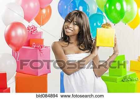 Picture - African American woman with birthday presents. Fotosearch