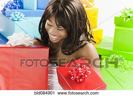 Stock Image - African American woman with birthday presents. Fotosearch
