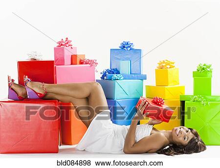 Stock Photo - African American woman with birthday presents. Fotosearch