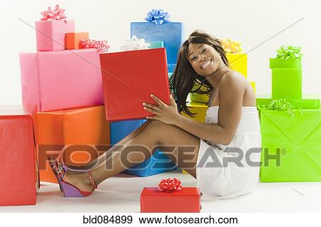 Stock Photo - African American woman with birthday presents. Fotosearch