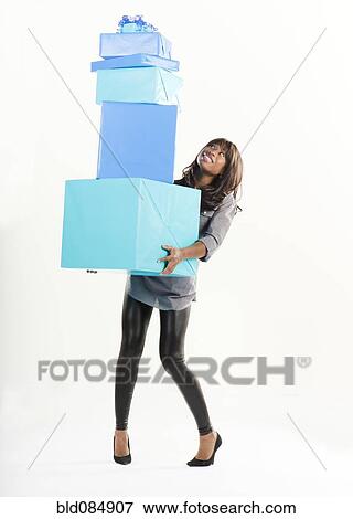 Stock Photo - African American woman with birthday presents. Fotosearch