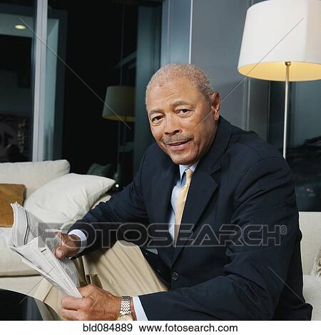 Stock Photo - Black businessman reading newspaper. Fotosearch