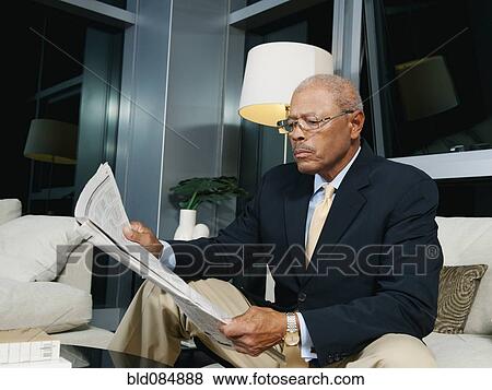 Stock Photo - Black businessmen reading newspaper. Fotosearch