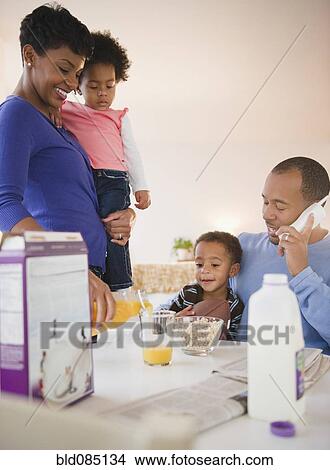 Picture - Black family eating breakfast together. Fotosearch