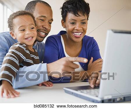 Black family using laptop together View Large Photo Image Stock Image - Black family using laptop together. Fotosearch
