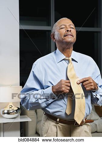 Black man adjusting tie View Large Photo Image Picture - Black man adjusting tie. Fotosearch