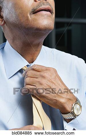 Black man adjusting tie View Large Photo Image Stock Photography - Black man adjusting tie. Fotosearch