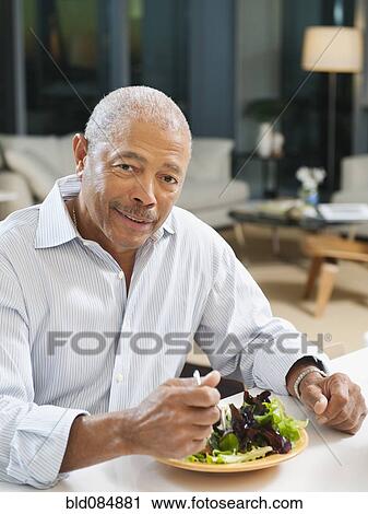 Black man eating salad View Large Photo Image Stock Image - Black man eating salad. Fotosearch