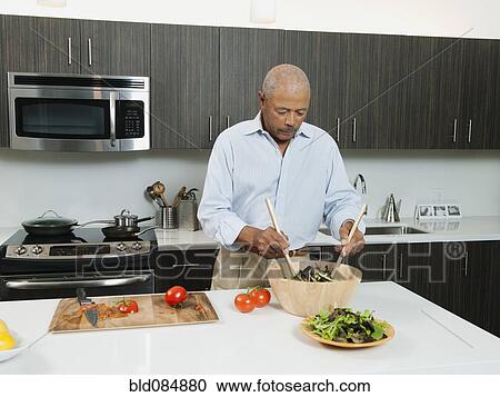 Black man preparing salad in kitchen View Large Photo Image Stock Image - Black man preparing salad in kitchen. Fotosearch