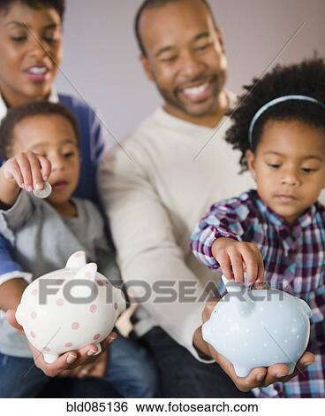 Black parents watching children put money in piggy bank View Large Photo Image Stock Photograph - Black parents watching children put money in piggy bank. Fotosearch