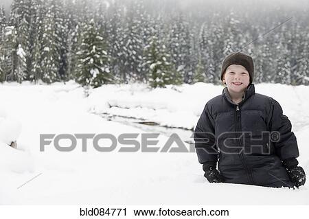 Stock Image - Caucasian boy enjoying the snow. Fotosearch