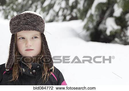 Stock Image - Caucasian girl in cap in the snow. Fotosearch