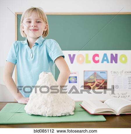 Caucasian girl standing with model volcano View Large Photo Image Stock Image - Caucasian girl standing with model volcano. Fotosearch
