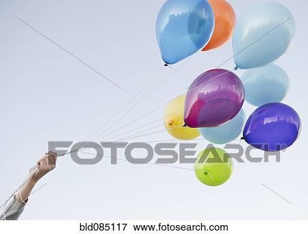 Caucasian woman holding bunch of balloons View Large Photo Image Stock Photo - Caucasian woman holding bunch of balloons. Fotosearch