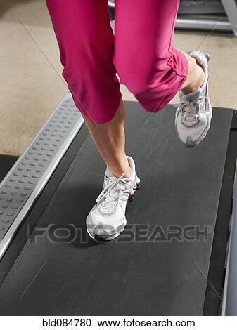 Caucasian woman's legs running on treadmill View Large Photo Image Stock Image - Caucasian woman's legs running on treadmill. Fotosearch