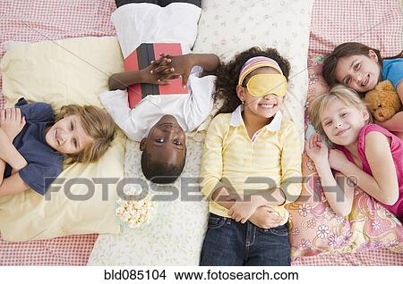 Picture - Children having slumber party together. Fotosearch