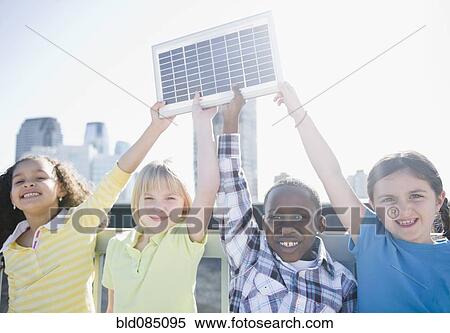 Children on rooftop holding up solar panel View Large Photo Image Stock Photography - Children on rooftop holding up solar panel. Fotosearch