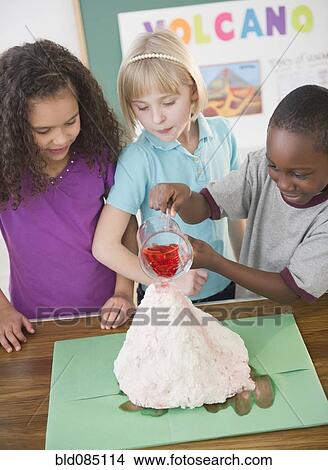 Children watching boy with model volcano View Large Photo Image Picture - Children watching boy with model volcano. Fotosearch