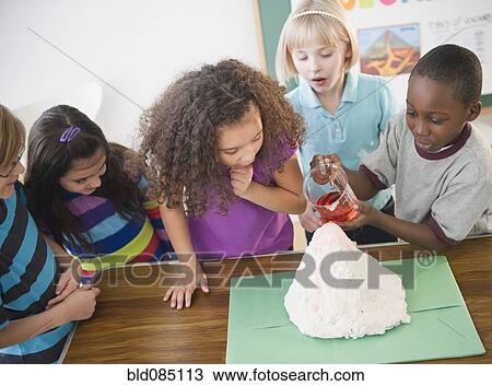 Children watching boy with model volcano View Large Photo Image Stock Image - Children watching boy with model volcano. Fotosearch