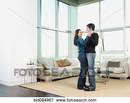 Stock Photo - Couple dancing together in living room. Fotosearch